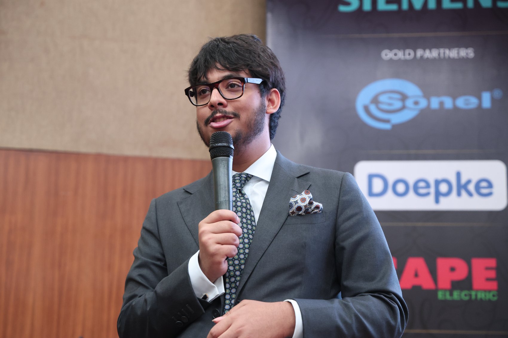 Krish Theobald speaking at an electrical safety event in Delhi, June 2025