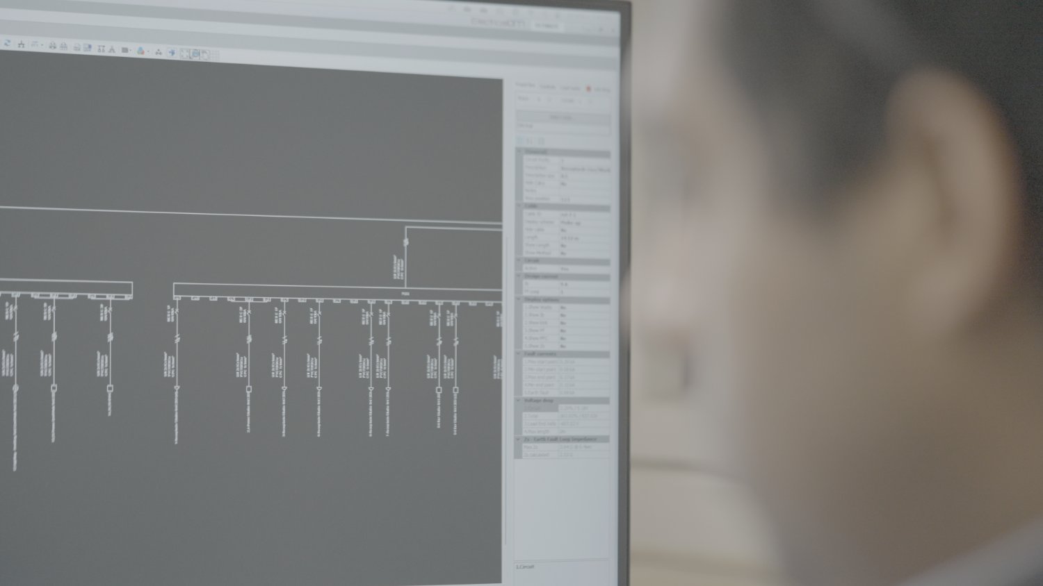 An electrical designer reviewing a single-line diagram in design software